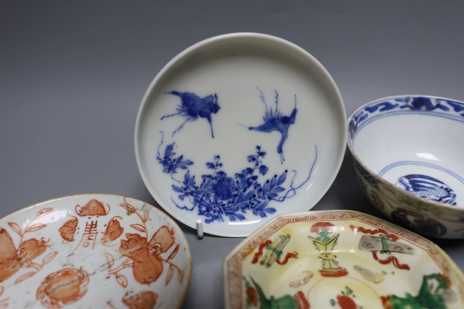 A Korean celadon bowl, a Chinese blue and white bowl, an iron red dish a famille Verte saucer and a Japanese blue and white saucer